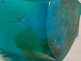 a close up of a toothbrush with a blue liquid on it