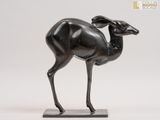 a bronze statue of an antelope on a marble base