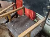 a chair that is sitting in a room with a red curtain