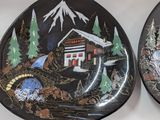 two decorative plates that are sitting on a table