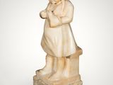 an image of a statue of a little girl sitting on a bench