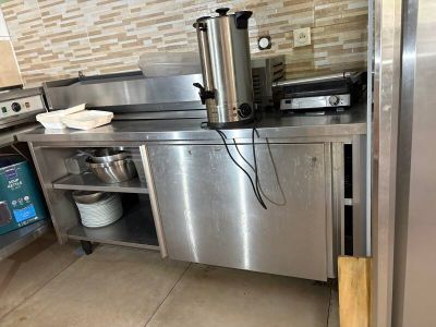 a stainless steel kitchen with a stove and a dishwasher on the counter