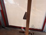 a wooden pole with a book on it in front of a window