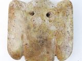 an elephant head made out of clay on a white surface