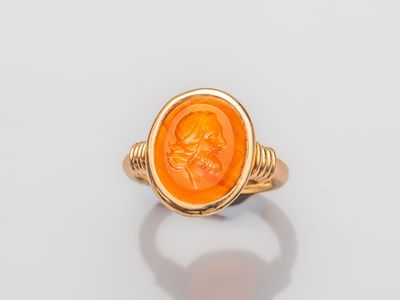 a gold ring with an image of a woman in profile