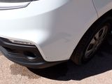 a close up of a white car parked in a parking lot