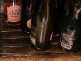 many bottles of alcohol sitting on a shelf in a room