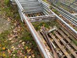 a fence that has been knocked over by a pile of wood