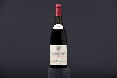 a bottle of wine sitting on top of a black table