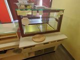 a counter with a glass display case and a bowl on top of it