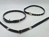 two black leather collars with silver buckles on a white background