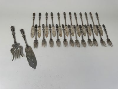several spoons and forks are lined up on a white surface