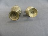 pair of antique brass candlesticks on a grey background