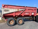 a red dump truck that is parked next to a tractor