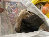 a person holding a bag full of stuff in it