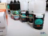 many bottles of different flavored liquids on a table