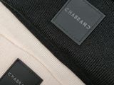 a close up of a black and white bag with a label on it