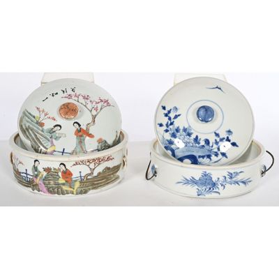 two chinese porcelain bowls with lids and lids are sitting on a white surface