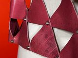 a close up of a mannequin torso with a red leather belt