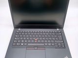 the laptop is open on a white surface with a black keyboard