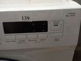 a washing machine that is sitting on the counter