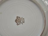 a white plate with a brown design on it