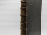 an old book sitting on top of a table next to a white background