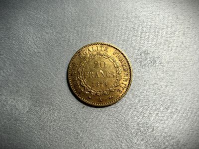 a gold coin with a crown on it sitting on top of a table
