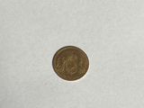 a close up of a coin on a white surface
