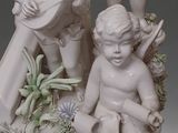 three figurines of children sitting on a rock