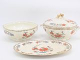 three pieces of porcelain dishes and a bowl on a white surface