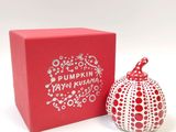a red box with a red and white apple next to it