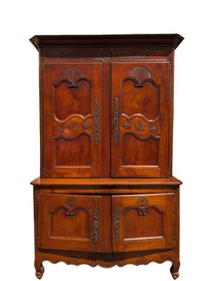 an old wooden cabinet with two doors and a drawer underneath it