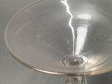 a clear glass bowl with a small white object in it