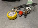 a close up of a gas can and a gauge on a table