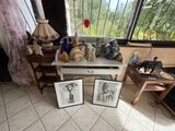 two framed pictures on a table in front of a window