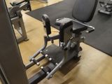 a gym room with machines and other equipment on the floor