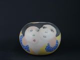 an egg shaped like a woman ' s face on a black background