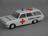 a white toy ambulance with a red cross on the roof