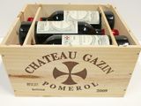 bottles of wine in a wooden box on a white surface
