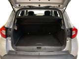 the back of a silver car with its trunk open and the back seats folded down