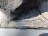 a large rock sitting on top of a metal object