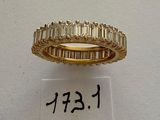 an image of a gold ring with baguets of diamonds
