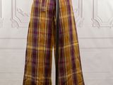 a close up of a mannequin wearing a yellow and purple plaid pants