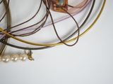 a lot of necklaces and bracelets on a table