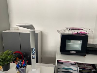 a microwave sitting on top of a desk next to a printer