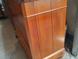 a wooden cabinet that has a marble top on it