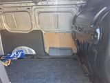 the interior of a van with the door open and a bag in the back of the van