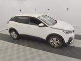 a white car is parked in a garage with a checkered floor