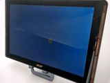 the acer tablet is sitting on top of a stand with a blue screen